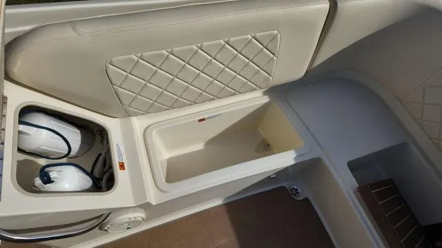 Slide: The Image of 2017 Chris-Craft Launch 27 interior with storage compartments and quilted upholstery. - 12