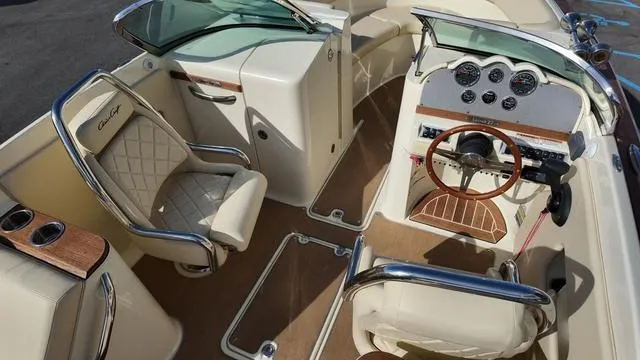 Slide: The Image of 2017 Chris-Craft Launch 27 boat interior with luxurious seating and classic dashboard design. - 16