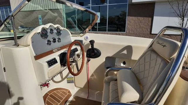 Slide: The Image of 2017 Chris-Craft Launch 27 boat interior with steering wheel and dashboard controls. - 17