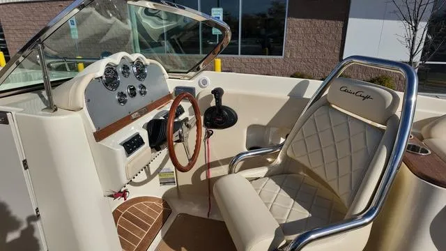 Slide: The Image of 2017 Chris-Craft Launch 27 boat interior with steering wheel and dashboard. - 18