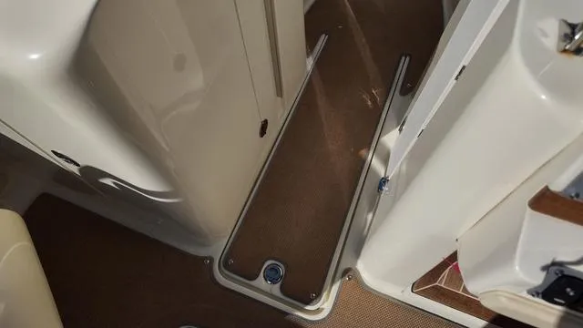 Slide: The Image of 2017 Chris-Craft Launch 27 interior with beige flooring and sleek design. - 25