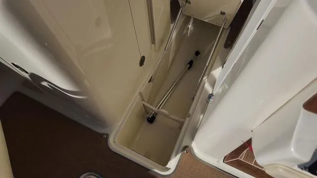 Slide: The Image of 2017 Chris-Craft Launch 27 storage compartment with open hatch, showcasing interior space. - 26