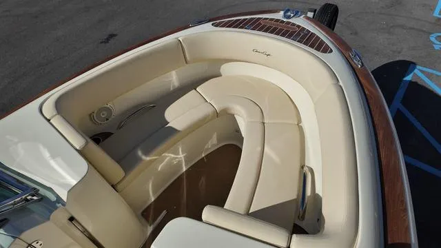 Slide: The Image of 2017 Chris-Craft Launch 27 boat with elegant cream seating and wooden accents. - 27