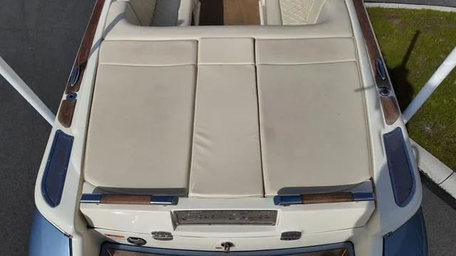 Slide: The Image of 2017 Chris-Craft Launch 27 boat, beige seating, wooden accents, aerial view. - 9