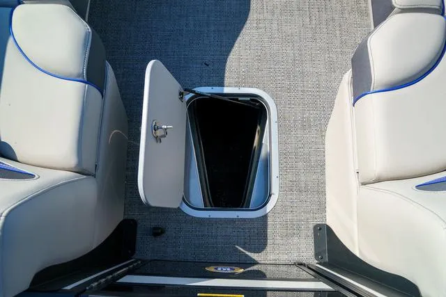 Slide: The Image of 2025 Barletta Corsa 23UC boat interior with open storage compartment and cushioned seating. - 10