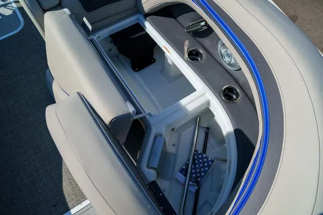 Slide: The Image of 2025 Barletta Corsa 23UC boat interior storage compartment with cup holders and seating. - 13