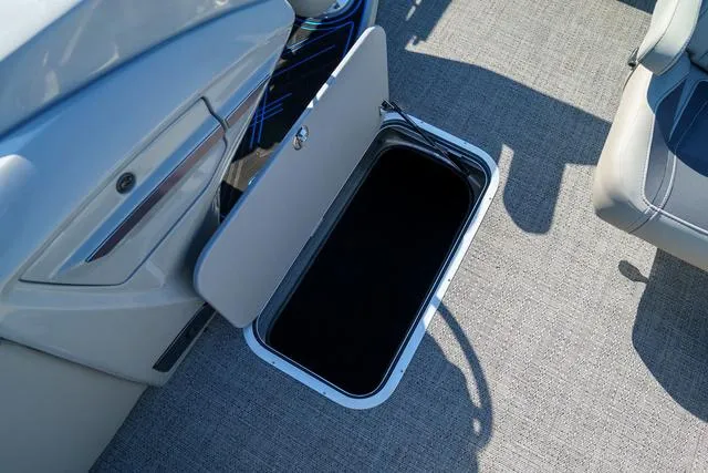 Slide: The Image of Open storage compartment on 2025 Barletta Corsa 23UC boat, featuring sleek interior design. - 15