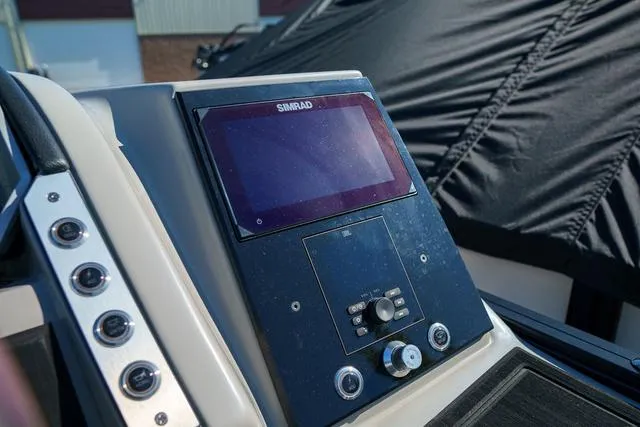 Slide: The Image of 2025 Barletta Corsa 23UC boat dashboard with Simrad navigation system. - 17