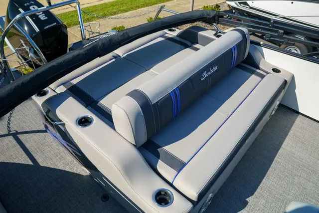 Slide: The Image of 2025 Barletta Corsa 23UC boat interior with cushioned seating and cup holders. - 21