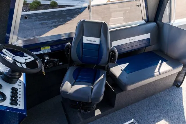 Slide: The Image of 2024 Thunder Jet Alexis Pro 22' boat interior with steering wheel and seating. - 10