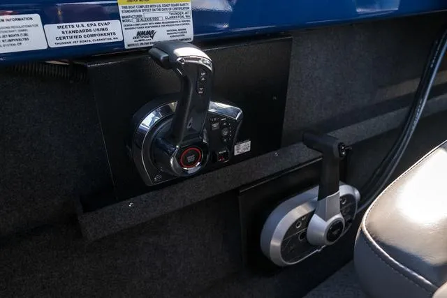 Slide: The Image of 2024 Thunder Jet Alexis Pro 22' boat controls and throttle lever in cockpit. - 11