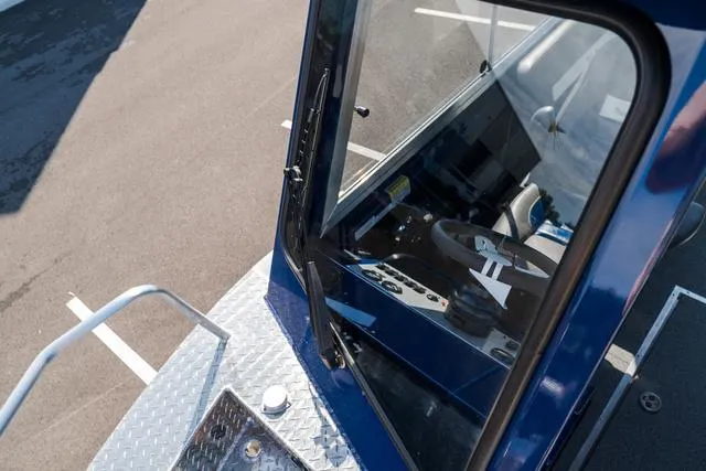 Slide: The Image of 2024 Thunder Jet Alexis Pro 22' boat cockpit view with steering wheel and controls. - 13