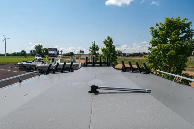 Slide: The Image of 2024 Thunder Jet Alexis Pro 22' boat roof with rod holders, outdoor setting. - 15
