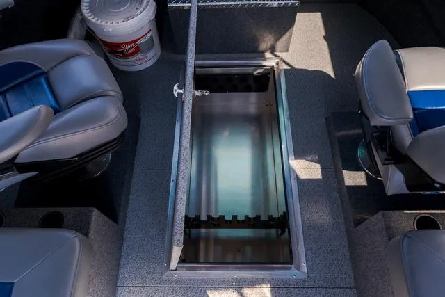 Slide: The Image of 2024 Thunder Jet Alexis Pro 22' interior with open storage compartment and seating. - 16