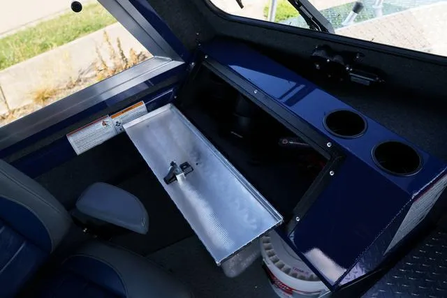 Slide: The Image of 2024 Thunder Jet Alexis Pro 22' interior with storage compartment and cup holders. - 17