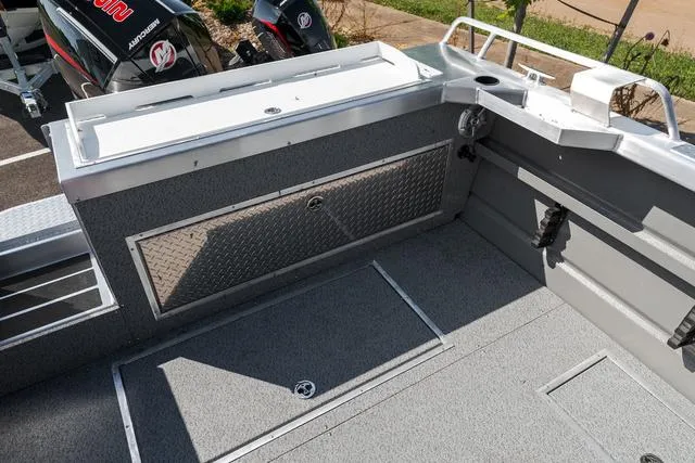 Slide: The Image of 2024 Thunder Jet Alexis Pro 22' boat deck with storage compartments and fishing rod holders. - 18