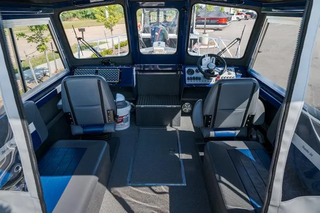 Slide: The Image of 2024 Thunder Jet Alexis Pro 22' boat interior with seating and steering console. - 6