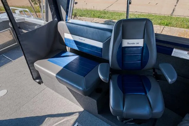 Slide: The Image of 2024 Thunder Jet Alexis Pro 22' interior with blue and gray seating, showcasing modern design. - 9