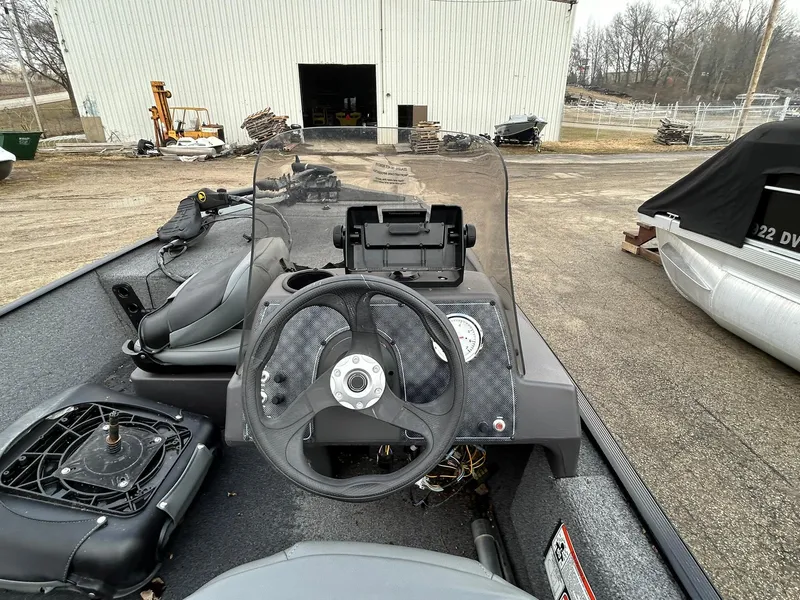 Slide: The Image of 2020 Tracker Bass Tracker Classic XL boat dashboard with steering wheel and control panel. - 12