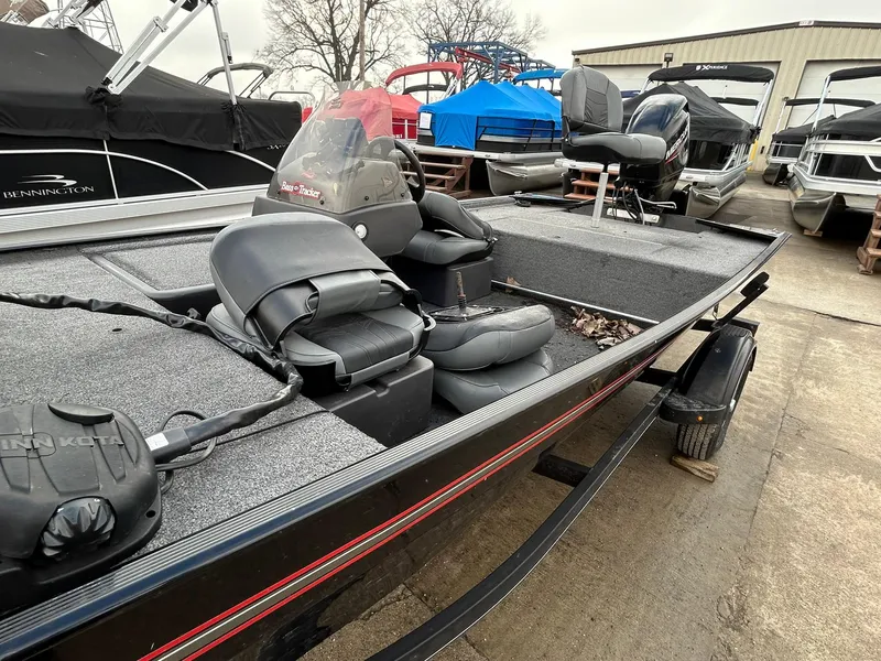 Slide: The Image of 2020 Tracker Bass Tracker Classic XL fishing boat with seating and storage, parked outdoors. - 9