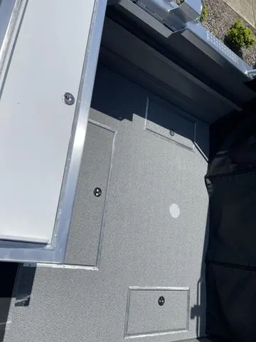 Slide: The Image of 2024 Thunder Jet Alexis OS 22' boat interior with storage compartments and sleek design. - 10