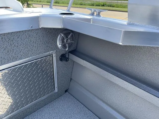 Slide: The Image of Interior of 2024 Thunder Jet Alexis OS 22' boat, featuring speaker and storage compartment. - 11