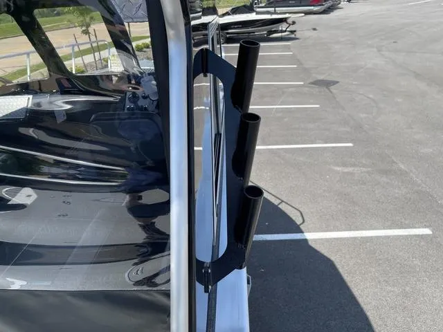 Slide: The Image of 2024 Thunder Jet Alexis OS 22' boat with rod holders in a parking lot. - 22