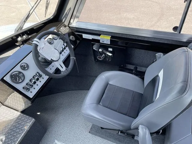 Slide: The Image of 2024 Thunder Jet Alexis OS 22' boat interior with steering wheel and control panel. - 31