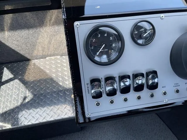 Slide: The Image of Control panel of 2024 Thunder Jet Alexis OS 22' boat with gauges and switches. - 33