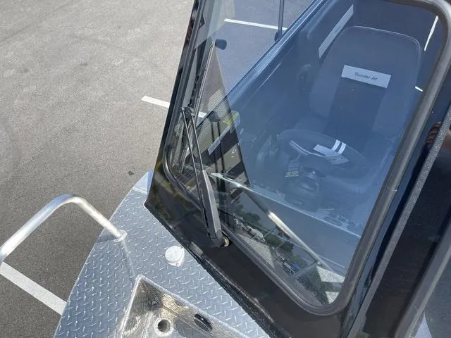 Slide: The Image of 2024 Thunder Jet Alexis OS 22' boat cockpit with windshield and seating. - 42