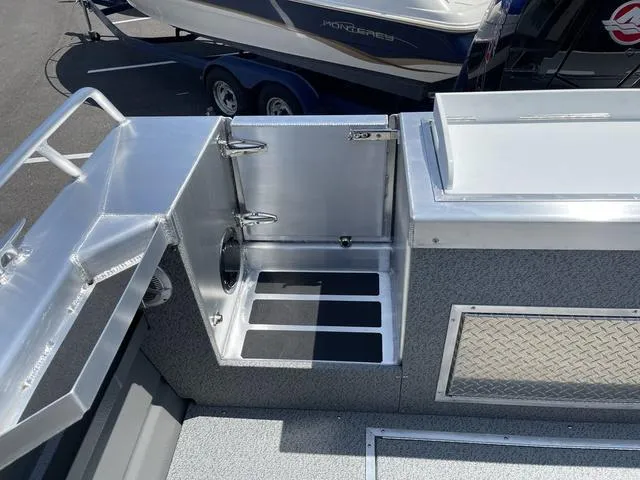 Slide: The Image of 2024 Thunder Jet Alexis OS 22' boat interior with stainless steel features and storage compartments. - 9