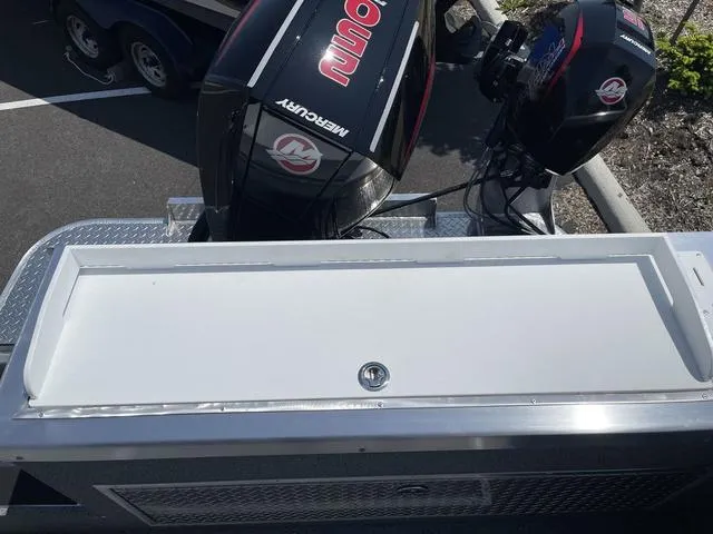 Slide: The Image of 2024 Thunder Jet Alexis OS 22' boat with dual Mercury outboard motors, parked on a trailer. - 12