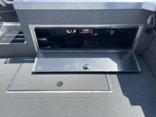 Slide: The Image of 2024 Thunder Jet Alexis OS 22' boat storage compartment with open hatch, revealing interior wiring. - 16