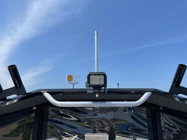 Slide: The Image of 2024 Thunder Jet Alexis OS 22' boat dashboard with antenna and light under clear blue sky. - 23