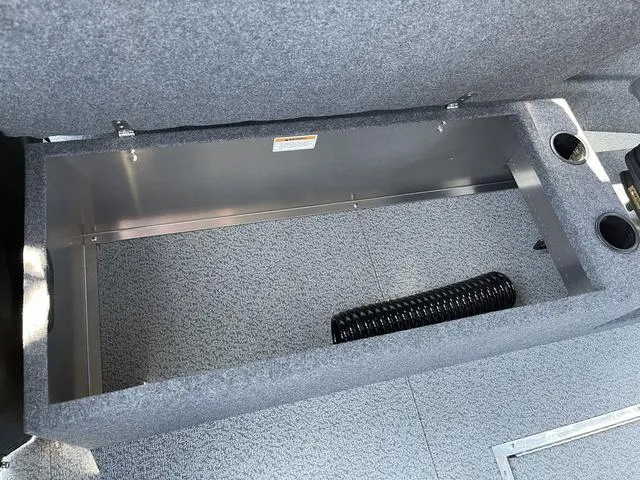 Slide: The Image of 2024 Thunder Jet Alexis OS 22' storage compartment with cup holders and coiled hose. - 27