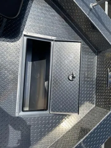 Slide: The Image of 2024 Thunder Jet Alexis OS 22' boat with open storage compartment on diamond plate deck. - 40