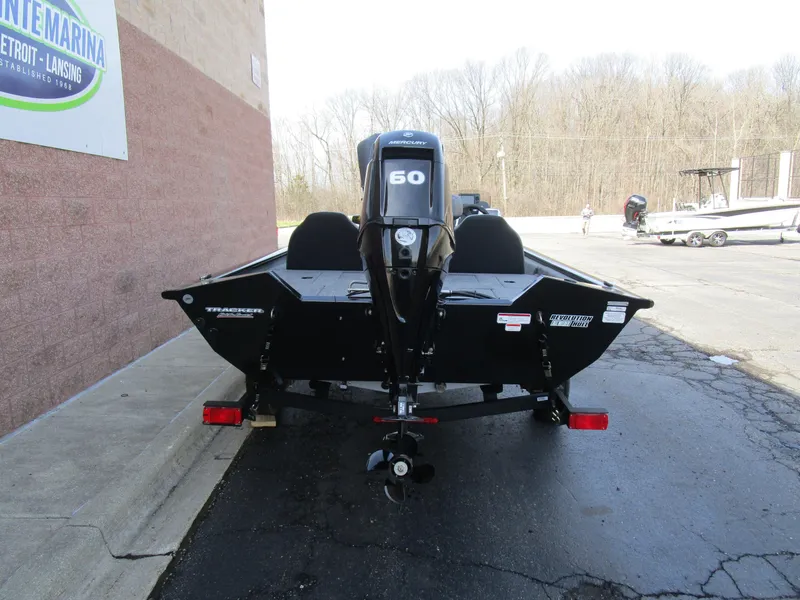 Slide: The Image of 2025 Tracker Pro Team 175 TXW boat with 60 HP engine, parked outdoors. - 11