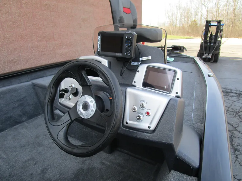 Slide: The Image of 2025 Tracker Pro Team 175 TXW boat dashboard with steering wheel and electronic displays. - 4