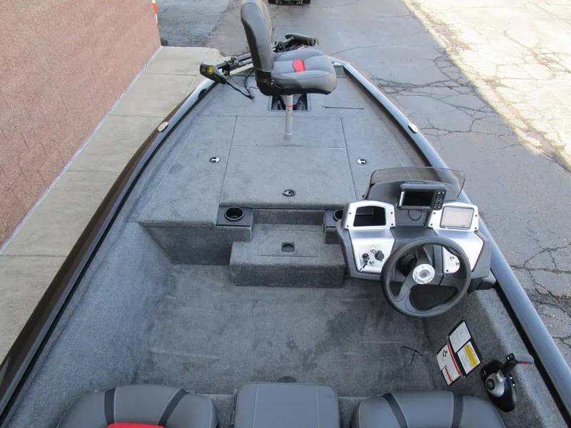 Slide: The Image of 2025 Tracker Pro Team 175 TXW boat interior with steering console and seating. - 6
