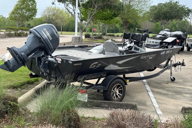Slide: The Image of 2020 G3 Sportsman 1610 boat with Yamaha motor in a parking lot. - 2