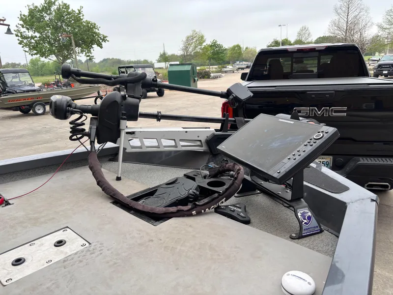 Slide: The Image of 2020 G3 Sportsman 1610 boat with advanced navigation equipment, parked near a GMC truck. - 3