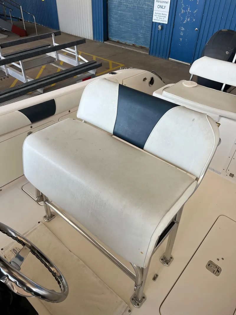 Slide: The Image of Century 2600 CC 2007 boat seat with white and blue upholstery in a marina setting. - 22