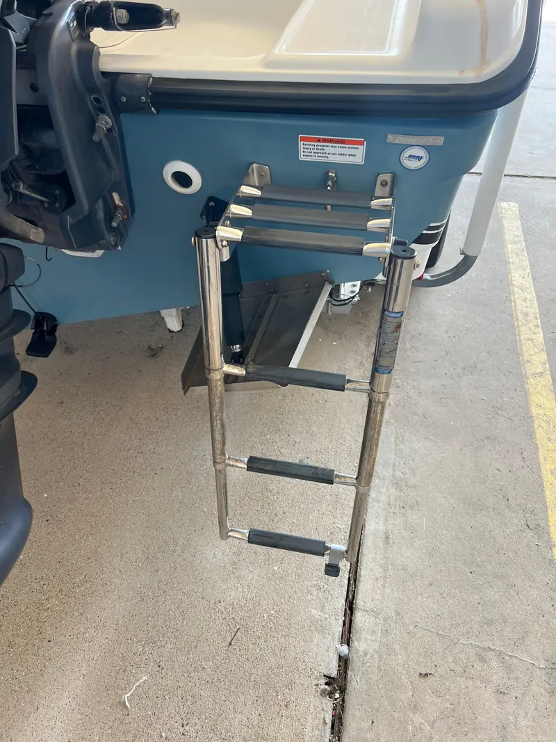 Slide: The Image of 2007 Century 2600 CC boat with a foldable metal ladder on the stern. - 27