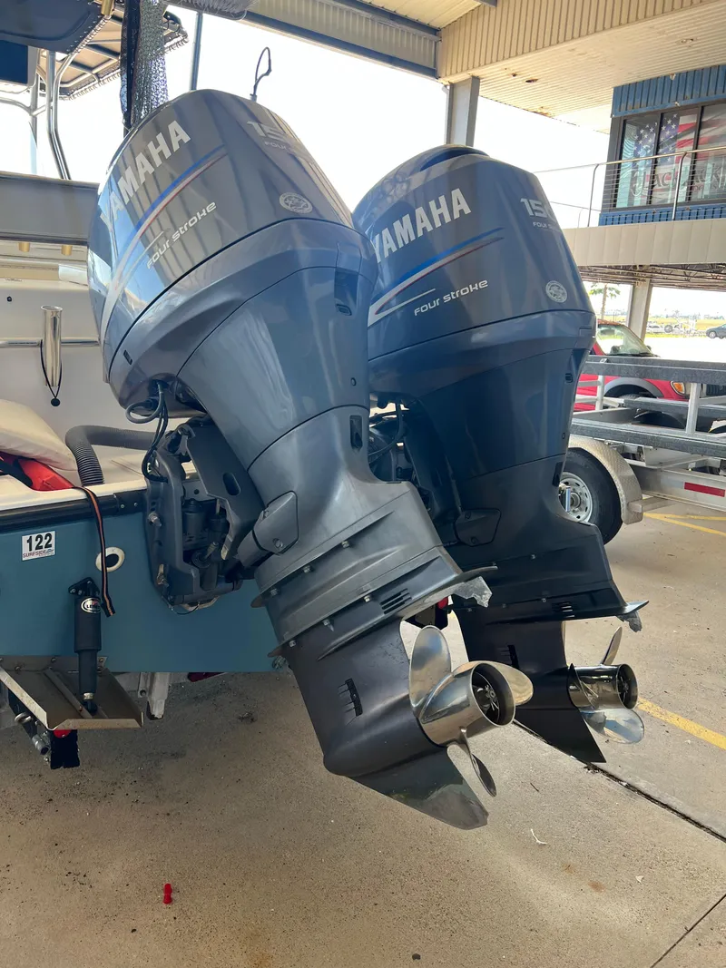 Slide: The Image of Twin Yamaha outboard motors on a 2007 Century 2600 CC boat in a marina setting. - 28