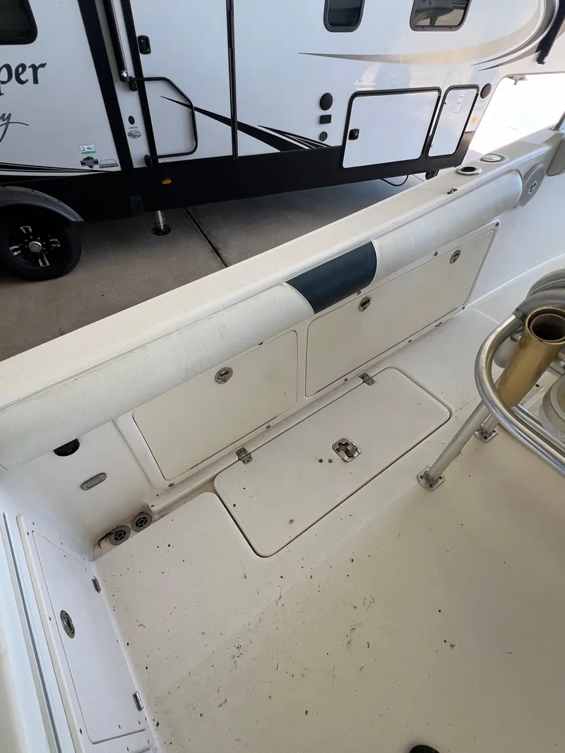 Slide: The Image of 2007 Century 2600 CC boat interior with storage compartments and fishing rod holders. - 35