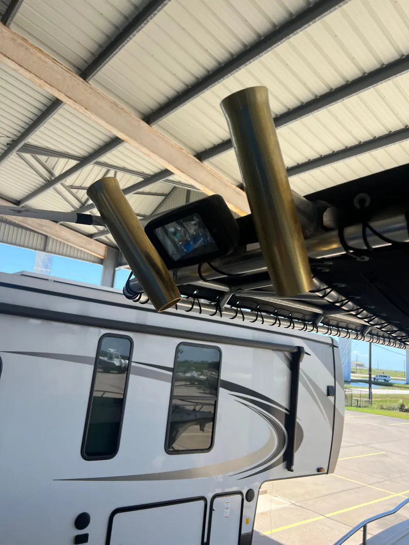 Slide: The Image of 2007 Century 2600 CC boat with rod holders and a light under a metal roof. - 40