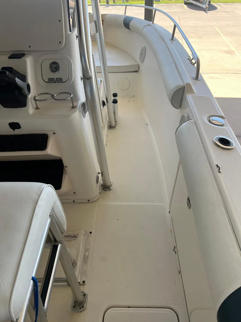 Slide: The Image of 2007 Century 2600 CC boat interior with white seating and storage compartments. - 42