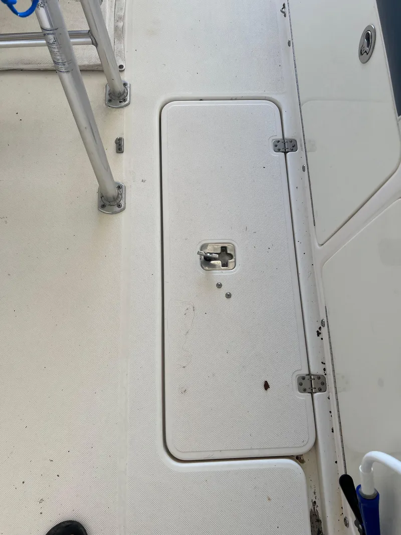 Slide: The Image of 2007 Century 2600 CC boat deck with storage compartment and metal railing. - 43