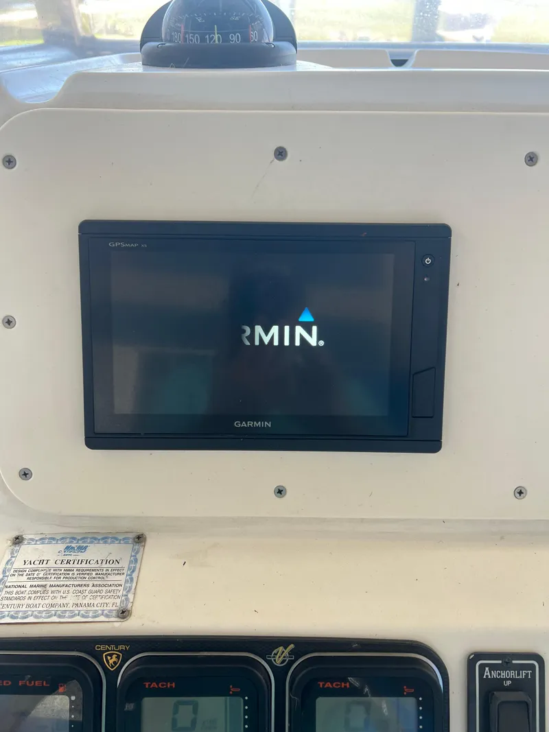 Slide: The Image of Garmin display on 2007 Century 2600 CC boat dashboard with gauges. - 47