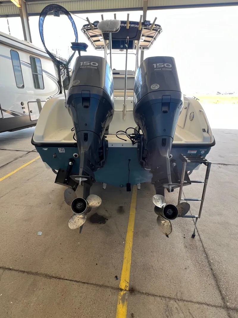 Slide: The Image of 2007 Century 2600 CC boat with dual 150 horsepower outboard engines in a storage facility. - 49